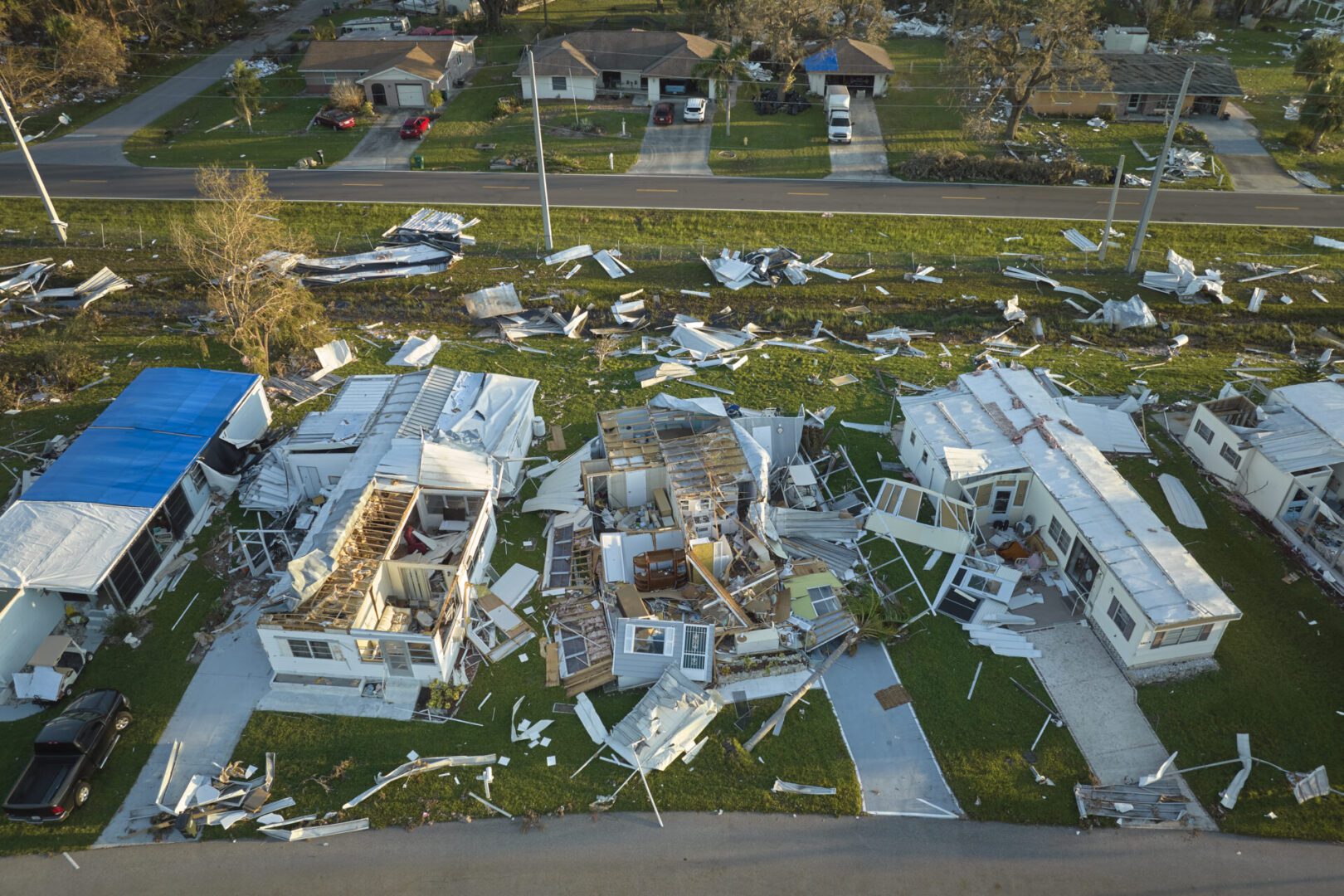 Hurricane Ian destroyed homes in Florida residential area. Natural disaster and its consequences.